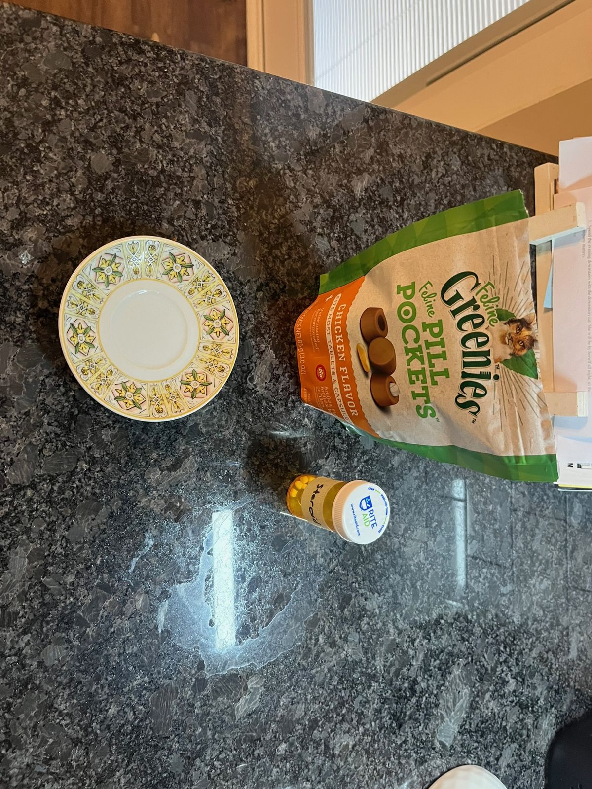 The plate, the pill pockets bag, and Joule's pill bottle